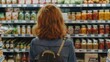 Woman browsing canned goods in grocery store, suitable for food and shopping concepts