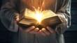 Hands holding glowing bible, people reading shiny magic book, closeup view.