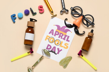 Sticker - Card with text APRIL FOOLS DAY, cosmetic products, facial massage tools and party decor on color background