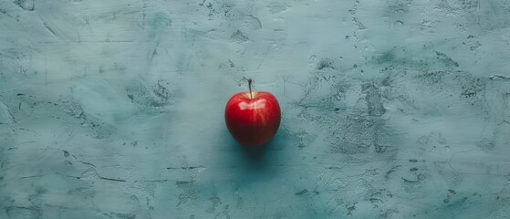 Sticker -   A lone red apple perched atop a blue-and-white wall, adjacent to a black-and-white tiled floor