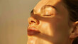 © JJ1990 - Close-up of serene woman's face basking in warm sunlight with shadows