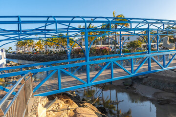 Wall Mural - A bridge over the river in the port of the touristic coastal town Mogan in the south of Gran Canaria. Spain