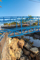 Wall Mural - A beautiful blue bridge in the port of the touristic coastal town Mogan in the south of Gran Canaria. Spain