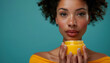 A beautiful dark-skinned model holds a jar of cream for healthy skin.