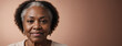 African American 70S Elderly Woman Isolated On A Peach Background With Copy Space