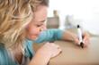 woman relocating writes on a cardboard box