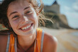 Joyful freckled woman smiling brightly in the sunlight.