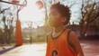 Young child practicing basketball free throws on an outdoor court at sunset