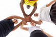 © ADDICTIVE STOCK - From a unique low angle, a basketball team's hands join together above, symbolizing team spirit and shared goals before the game