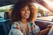 young adult woman driving a car, smiling joyfully, hands on steering wheel, african american