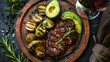 A top-down view of a wooden plate adorned with a delicious and nutritious meal featuring avocado slices, a savory steak seasoned with rosemary, accompanied by a glass of red wine
