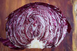 Cross section of a head of Radicchio on a wood background, food, vegetable, isolated