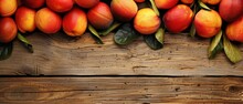   A Close-up Photo Of Juicy Peaches Resting On A Wooden Tabletop Surrounded By Green Foliage
