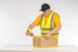 Man packer at work. Warehouse worker seals box with tape. Dispenser with tape in hands man. Packer guy is near table. Businessman is preparing parcel for shipment. Packer of goods from online store