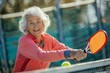Senior woman playing pickleball, happy and active