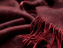A Red Scarf With A Fringe Is Shown In The Image. The Scarf Is Made Of A Soft, Fuzzy Material And Has A Long, Flowing Fringe. Concept Of Warmth And Comfort
