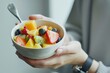 Fresh fruit salad from raw pieces in a white bowl in the hands of a young woman, Generative AI