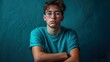 © LVSN - An image captures a young man with acne, pimples, and imperfections, wearing glasses and a turquoise t-shirt, embracing his authentic self