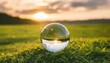 glass globe is sitting on top of vibrant and lush green field this image can be used to represent concepts such as sustainability global perspective and environmental awareness