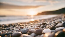 Close Up Of Pebble Stones And Rocks On A Beach With Sunset Bokeh Light Background Generative Ai