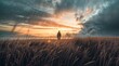 Man standing on the grassland at sunset with clouds in the sky
