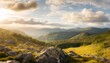 landscape of mountains and green hills summer nature landscape with rocks forest grass sun sky and clouds national park or reserve