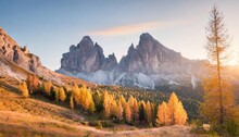 gorgeous sunny view of dolomite alps with yellow larch trees colorful autumn scene of ponta dei lastoi mountain range giau pass location italy europe beauty of nature concept background