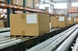 Cardboard boxes moving on conveyor belt in warehouse, logistics concept