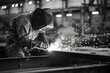 © InfiniteStudio - Welder in mask working with metal in workshop