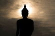 Silhouette of a large Buddha statue with a beautiful sky and clouds in the Phutthamonthon district, Thailand