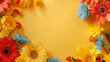 A bunch of vibrant summer flowers arranged on a bright yellow background. Copy space.