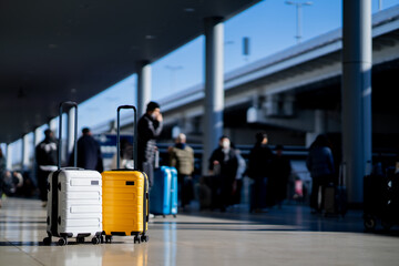 Wall Mural - Travel, Two suitcases in an empty airport hall, traveler cases in the departure airport terminal waiting for the area, vacation concept, blank space for text message or design