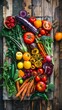 Colorful variety of raw vegetables and fruits on wood