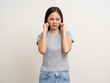© Chanakon - Young Woman stressed and frustrated covering her ears with her hands due to loud noise. Annoyed noise sound pollution. Asian Woman blocking ears