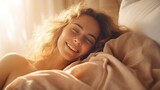 Fototapeta  - Cute young woman lying under blanket and smiling sleeping having a good morning nap lazy day in bed