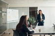 © Flamingo Images - Female CEO smiling during team meeting in an office boardroom