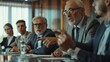 © Vesovic  - GSenior executive leading a business meeting. An older businessman with glasses leading a discussion at a corporate meeting