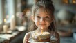 Young girl with a birthday cake and a lit candle, making a wish.