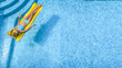 Beautiful woman in hat in swimming pool aerial drone view from above, young girl in bikini relaxes and swims on inflatable mattress and has fun in water on vacation, tropical holiday resort
