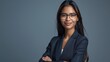 Confident smile of elegant Indian businesswoman wearing suit glasses looking at camera