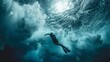 Free diver swimming underwater with flippers in the deep sea with dynamic light rays and bubbles