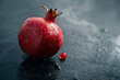 pomegranate with drops of water on dark background