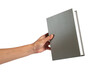 © apinya - Blank grey book cover in hand on transparent background.
