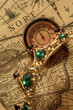 Luxury watch and crown on an ancient map