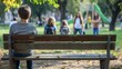 A young teenager sits contemplatively on a park bench, feeling isolated with blurred figures in the background during a sunny autumn day. bullying among teenagers