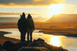 Couple of tourists enjoying beautiful sunset over Icelandic landscape during their trip to Iceland.