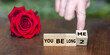 Wooden cubes form the expression 'you belong 2 me'.
