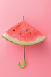 
umbrella made of watermelon isolated on pastel pink background, creative minimalist summer vacation concept