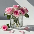 Bouquet of fresh pink roses on glass vase, hard light