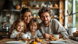 happy family with two kids sitting at table and looking at camera in kitchen